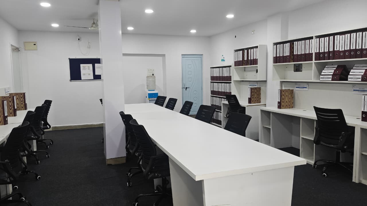 Open-plan floor with shared work tables and document storage